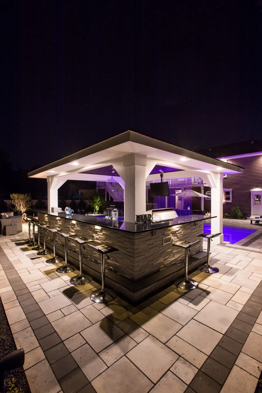 Outdoor bar seating behind custom pavilion in Brookhaven