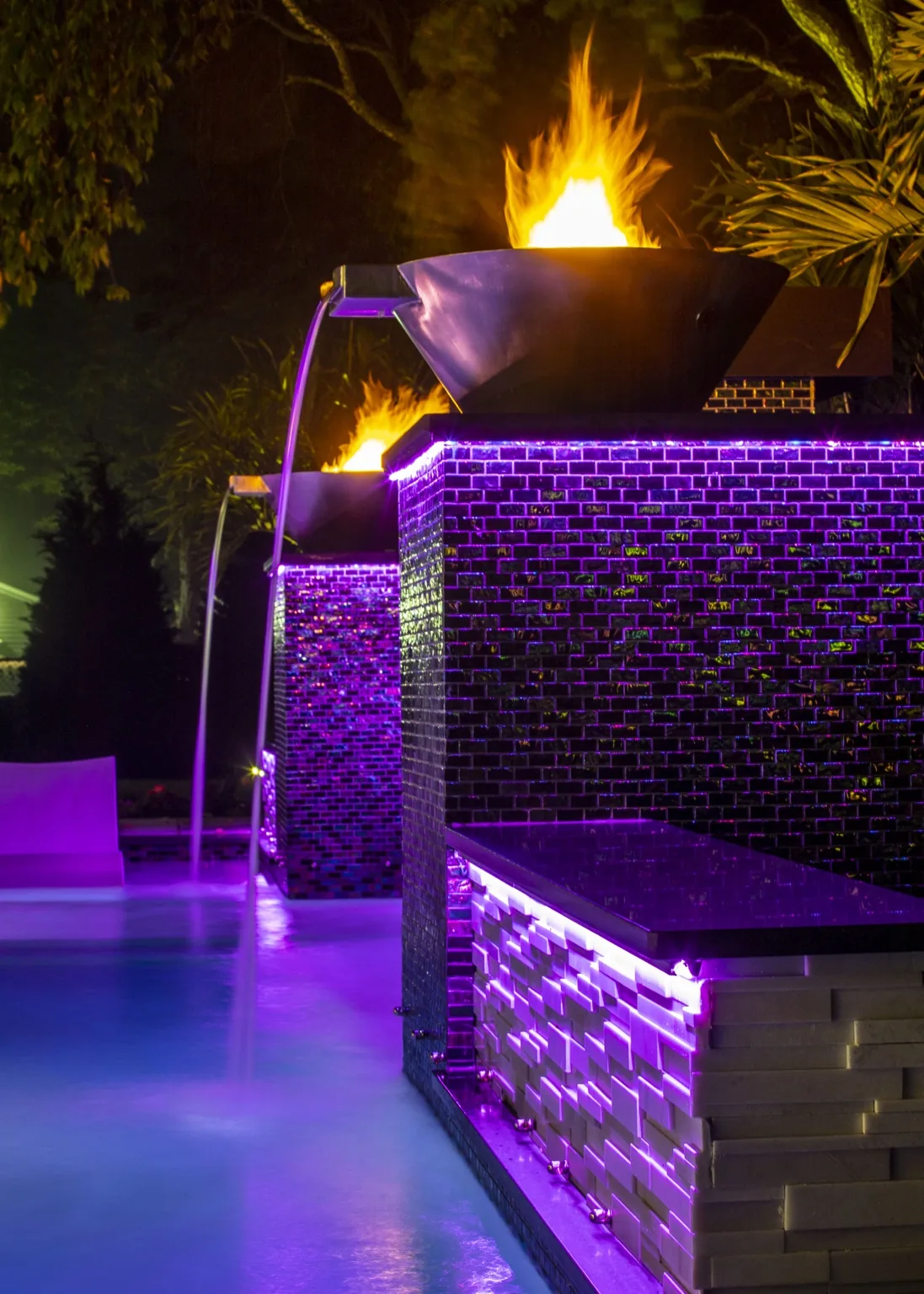 Dix Hills Miami-inspired backyard with covered outdoor entertaining space