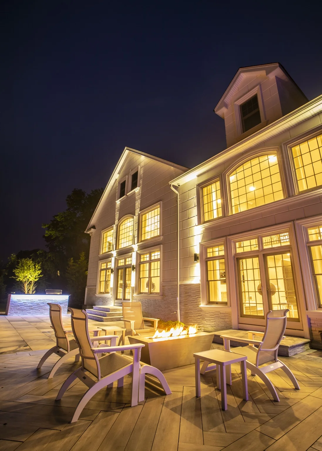 Dix Hills luxury backyard with pool, pavilion, firepit and architectural lighting