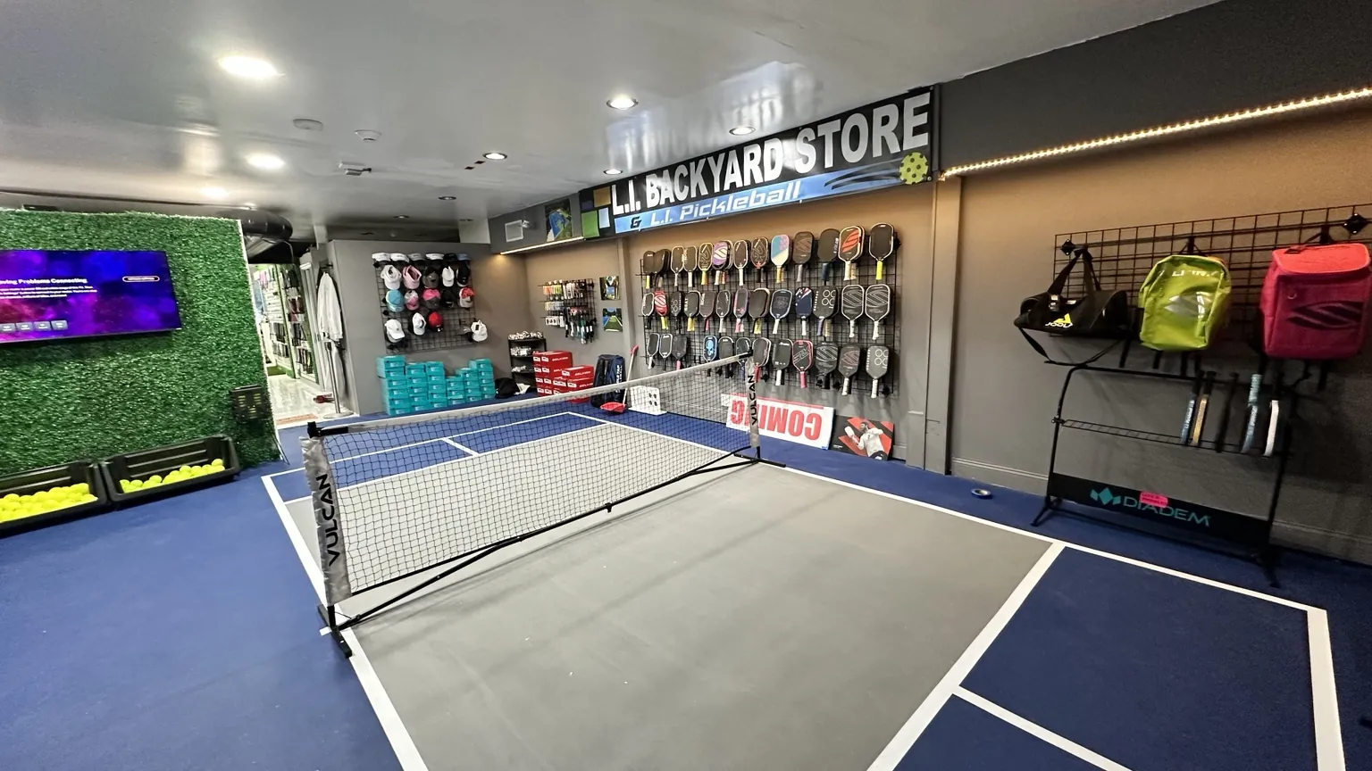 L.I. Pickleball showroom demo court and paddle wall