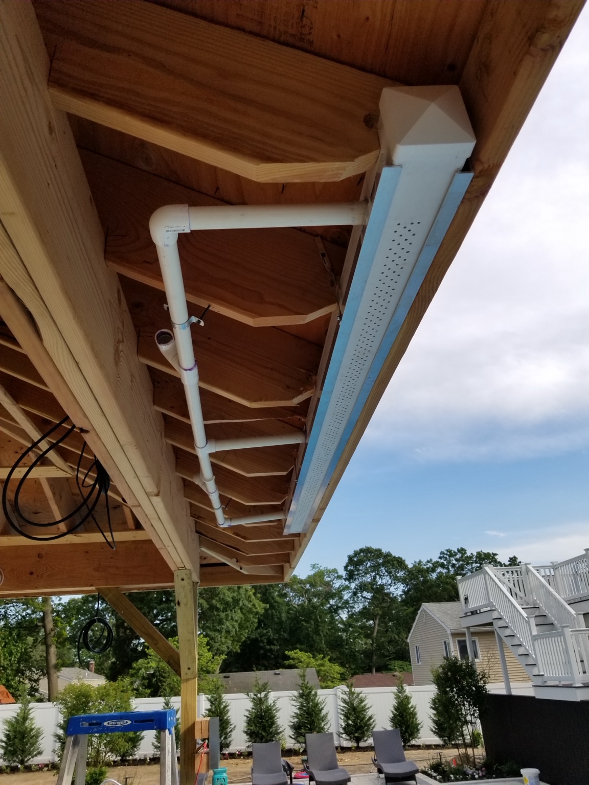 Rain curtain plumbing installed into pavilion roof