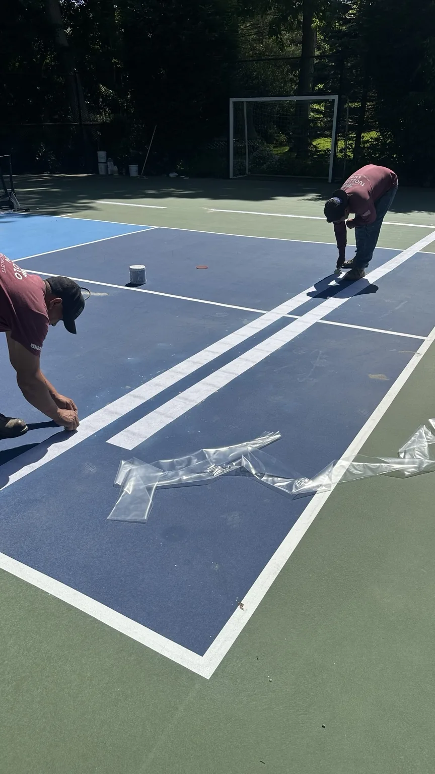 Crew installing new pickleball court lines in Melville