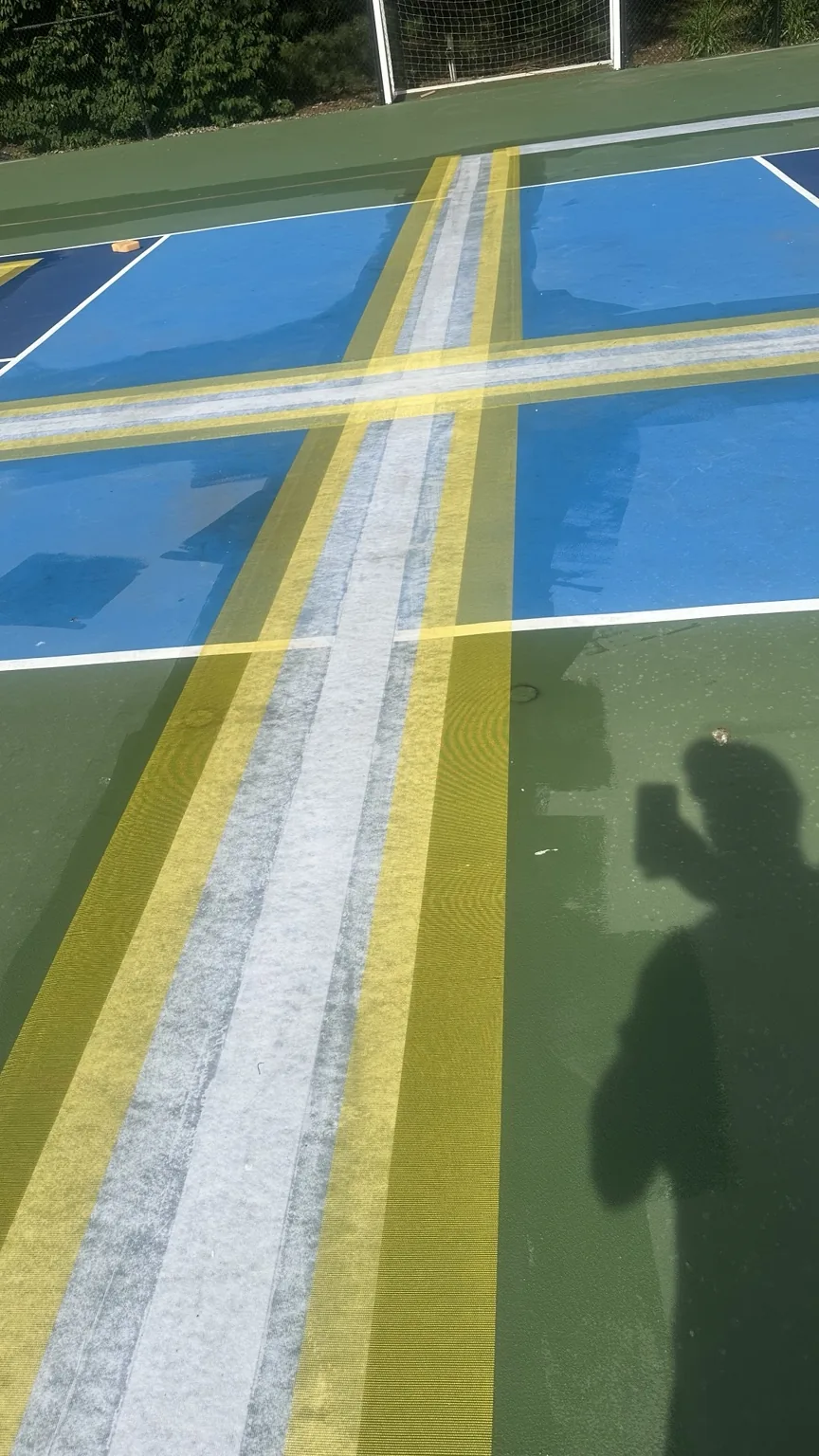 Taped court lines during pickleball resurfacing