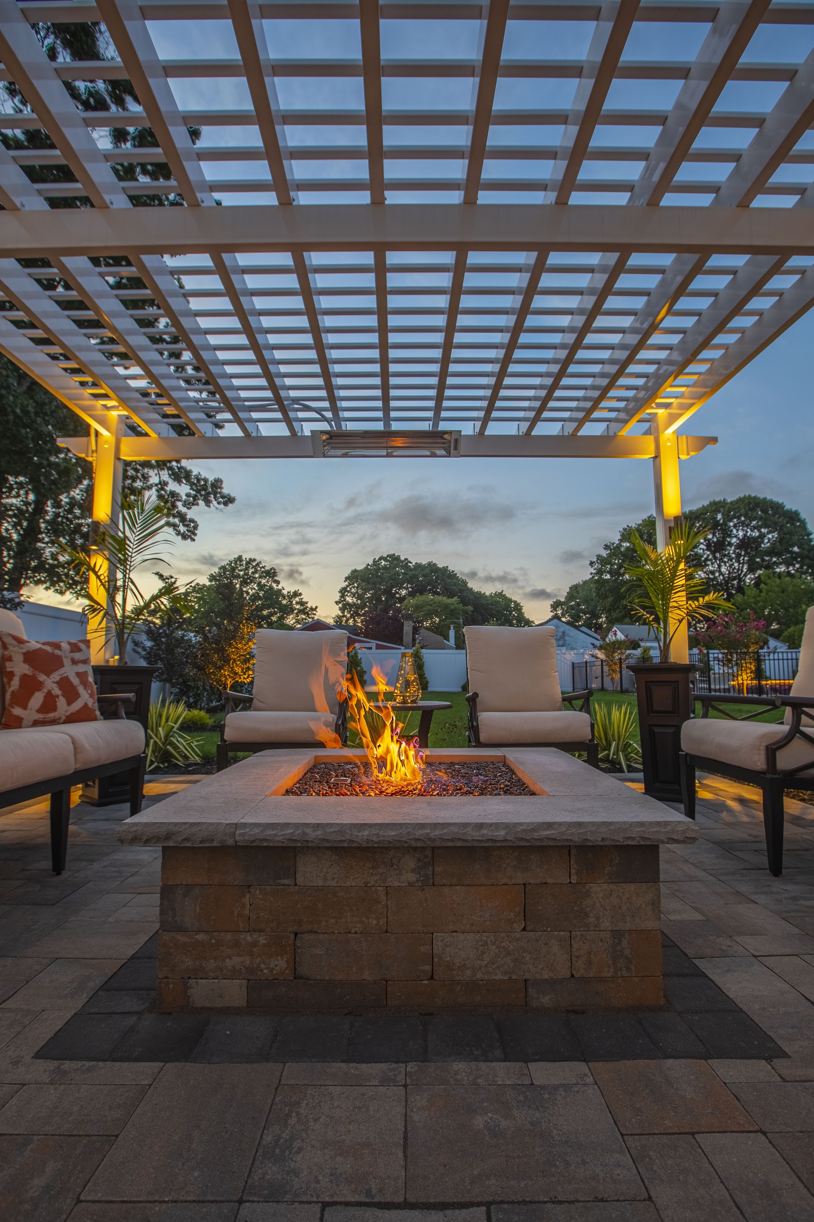 Finished pergola and fire pit at dusk