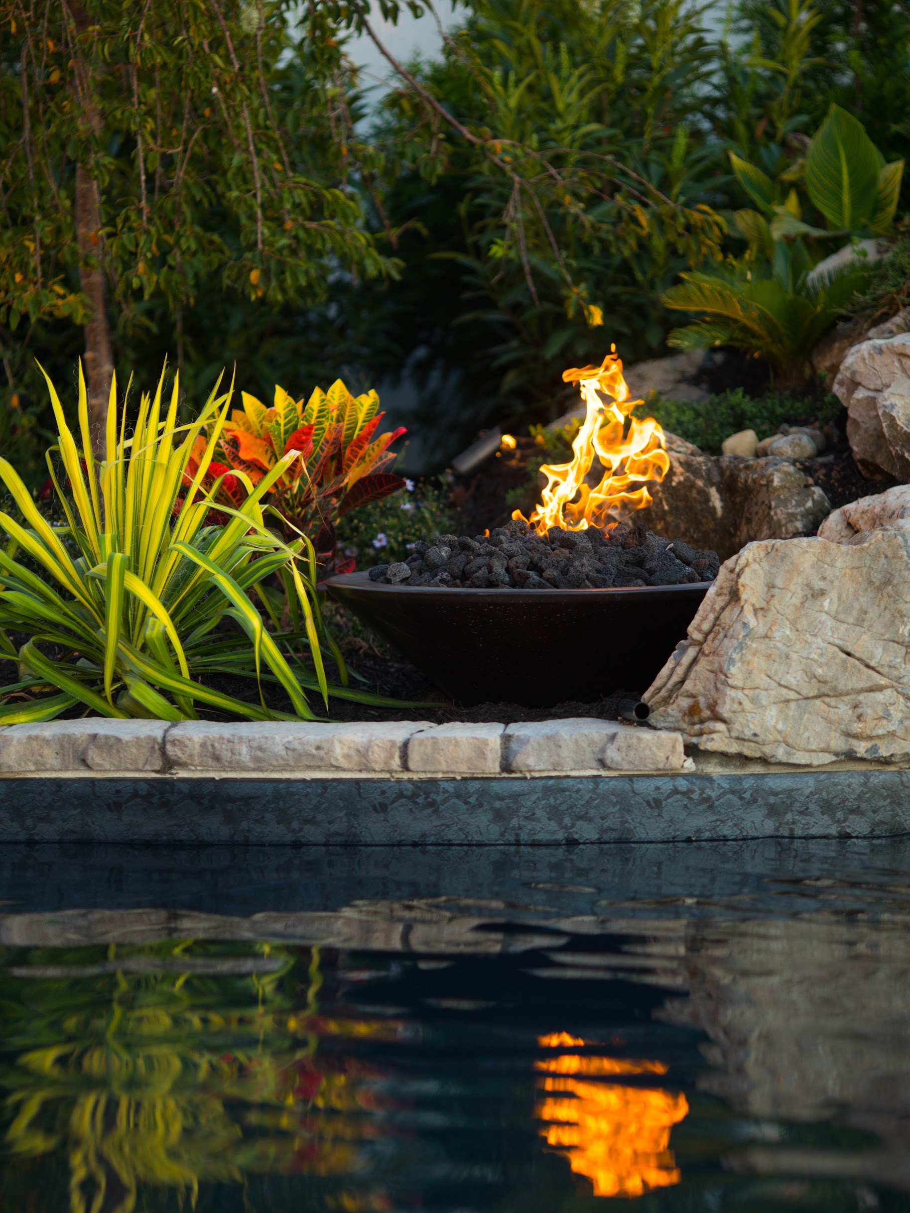 Fire feature reflected in waterfront pool