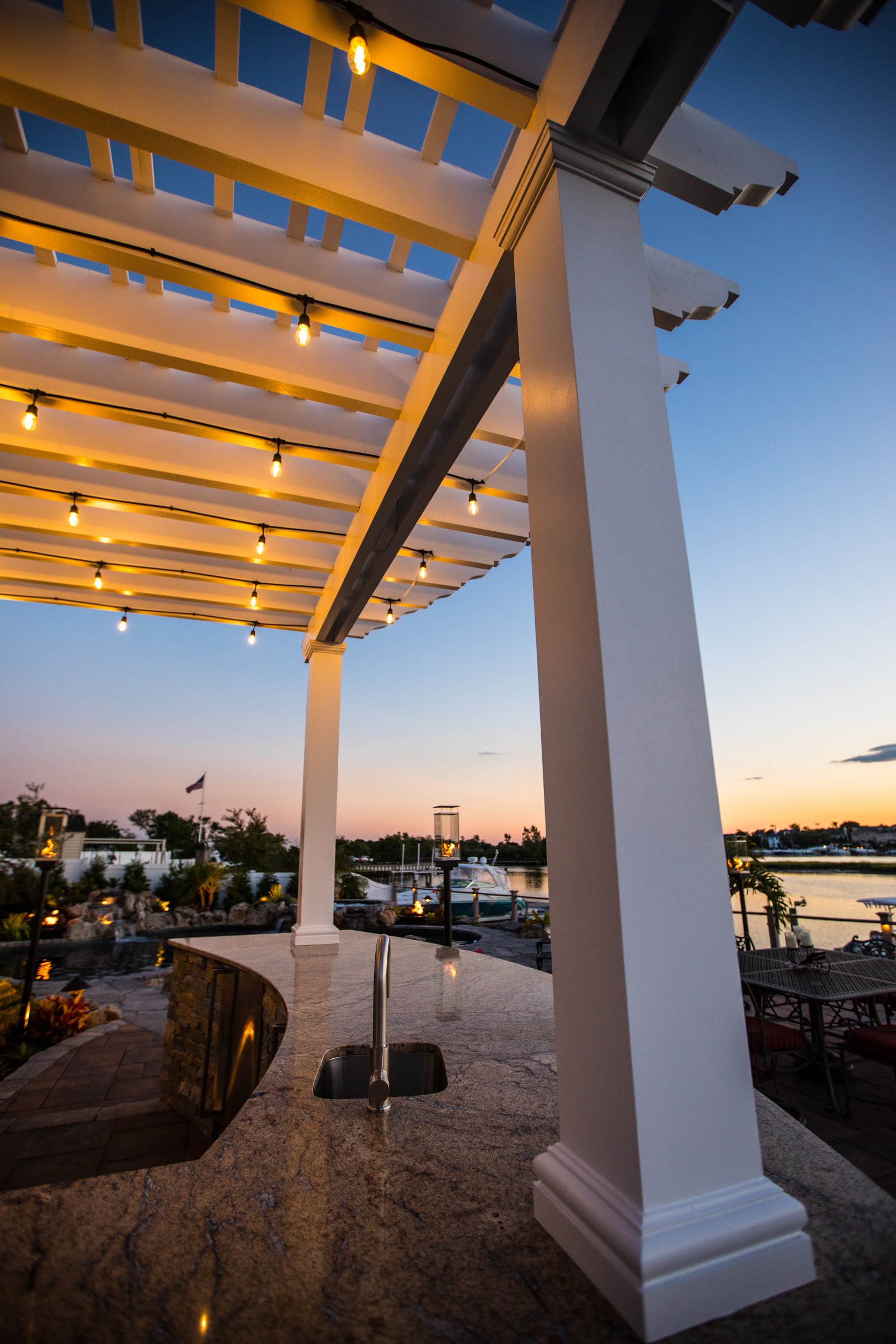Outdoor kitchen sink and pergola overlooking waterfront