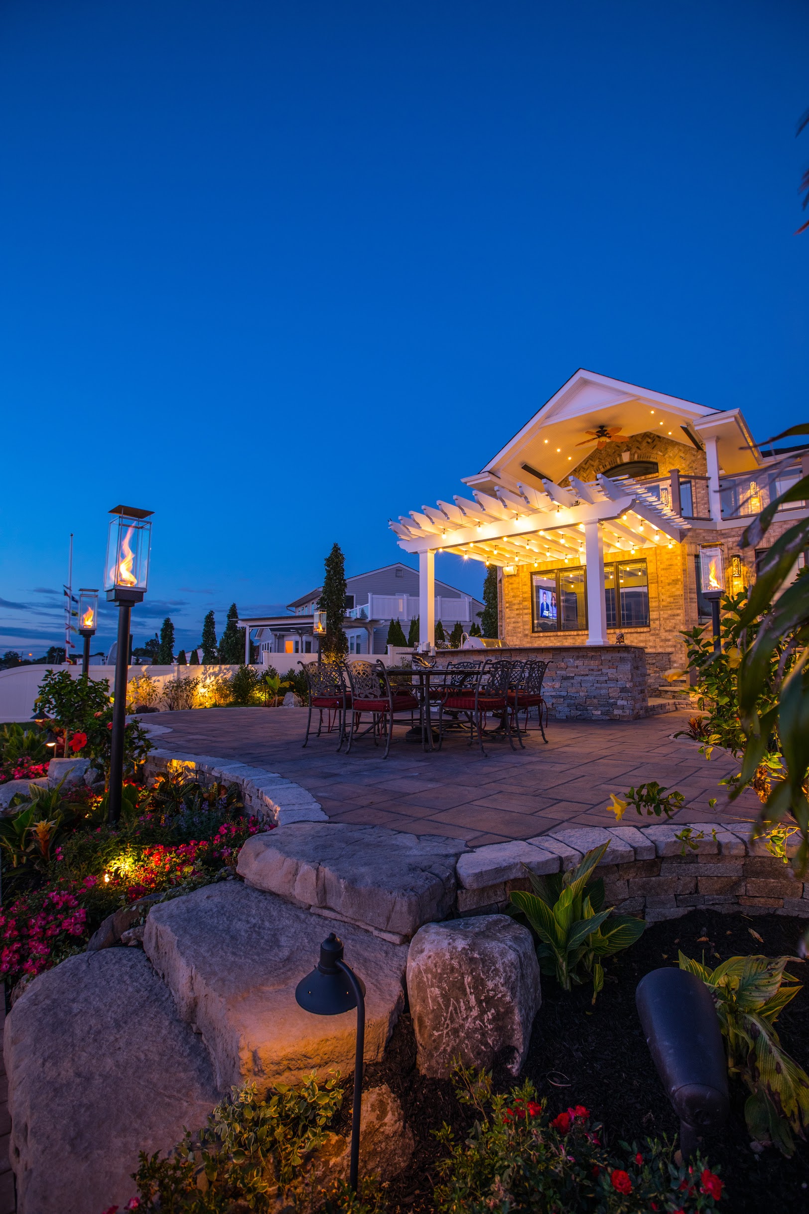 Waterfront pergola and architectural fire features at blue hour