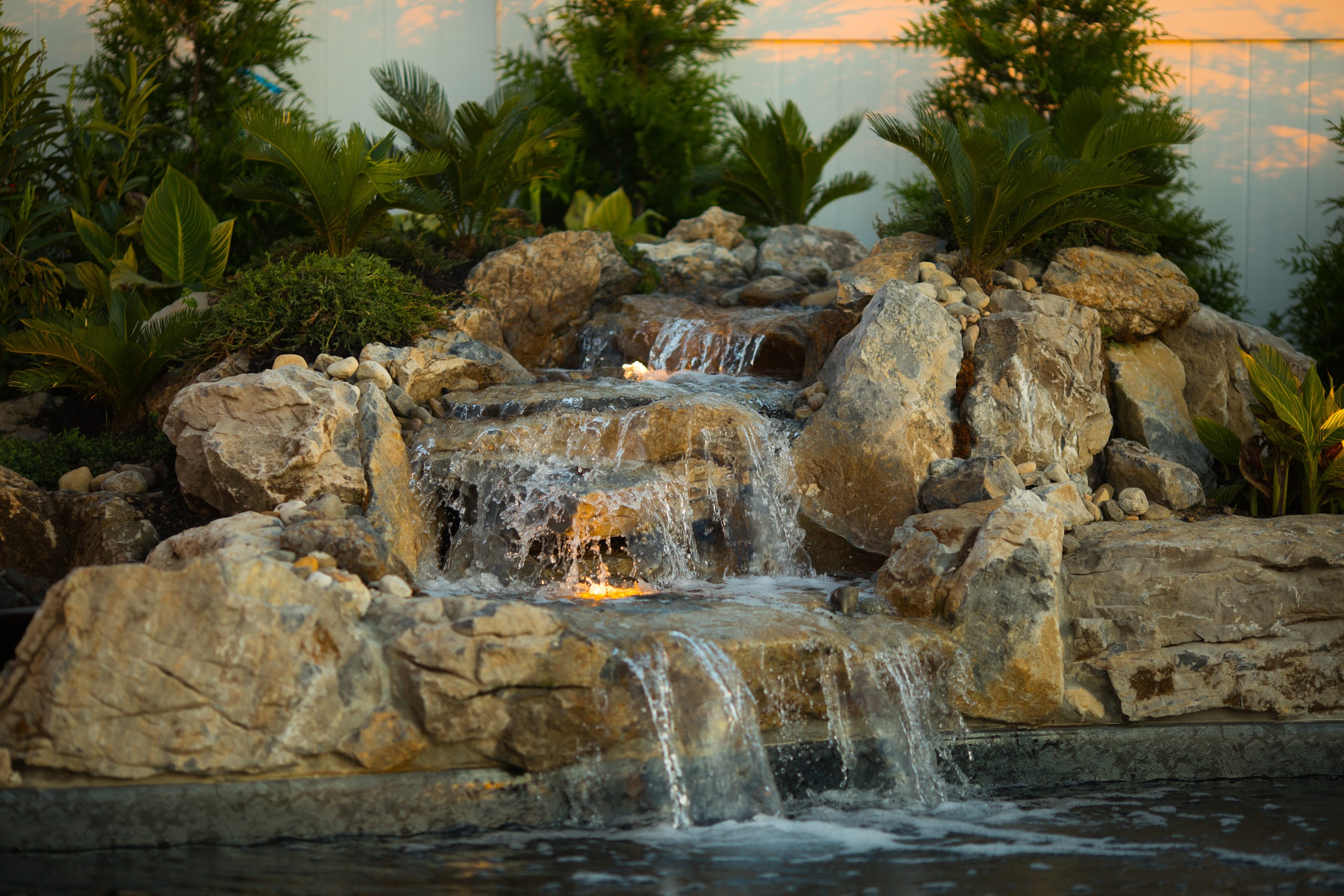 Natural stone waterfall built into swimming pool